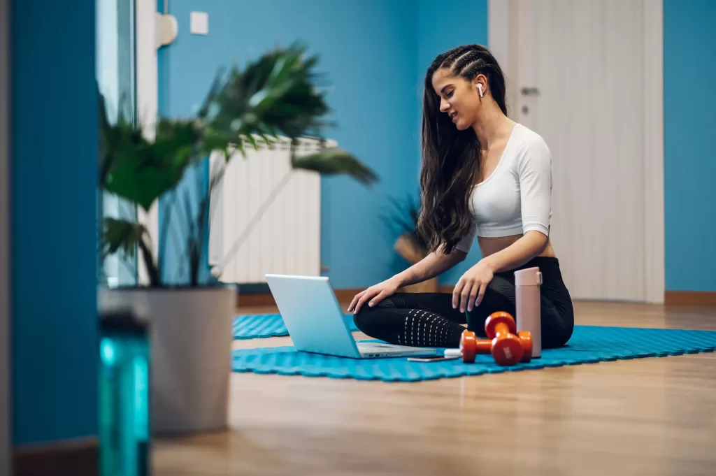 young woman on a video call with her personal trainer coming up with a workout plan
